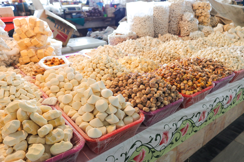 Various types of dried cheese in a market of Uzbekistan